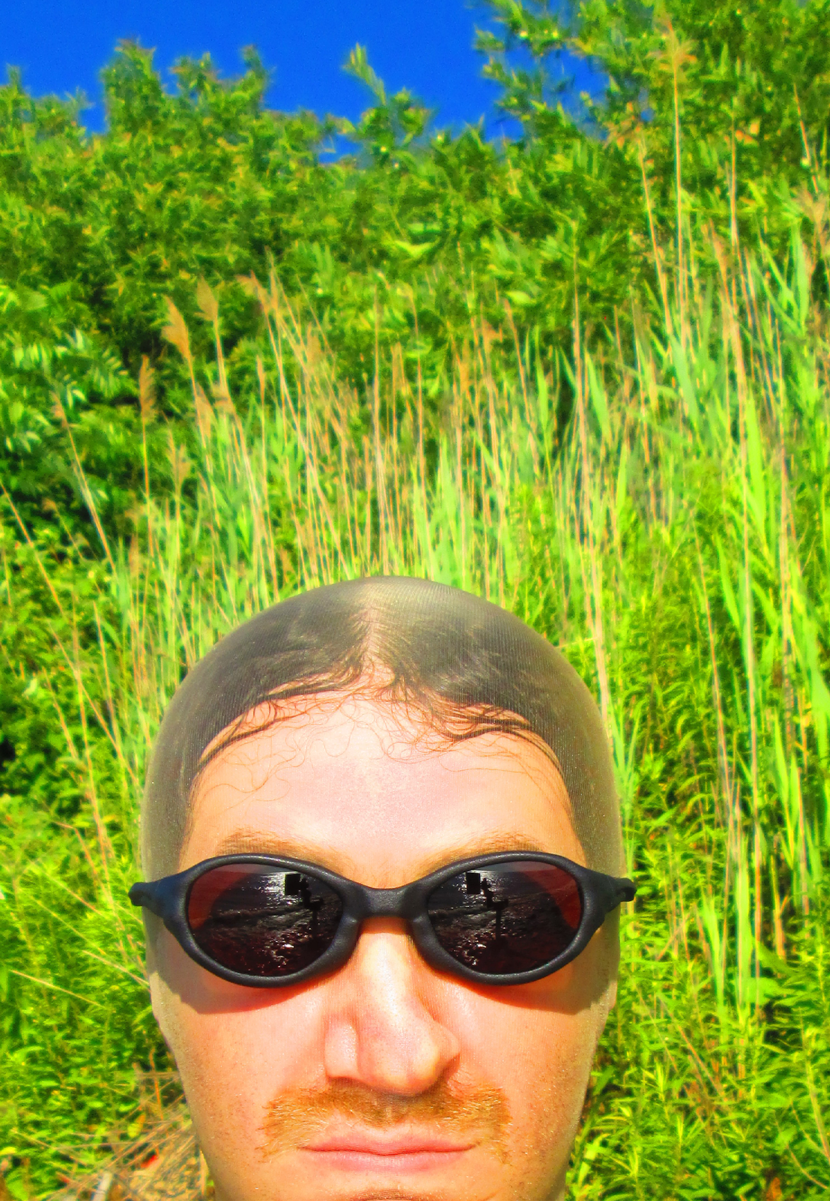 3D render of a bald model wearing black sunglasses with transparent grey lenses